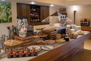 a buffet with a lot of food on a table at Artemis Hotel in Cefalù