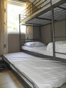 two bunk beds in a room with a window at Fjellheim in Herlø