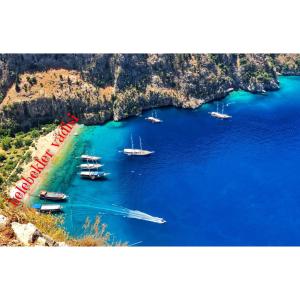 an aerial view of a bay with boats in the water at İlkiz Beach Hotel in Oludeniz