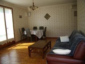 a living room with a couch and a table at Comme chez vous in Bayons