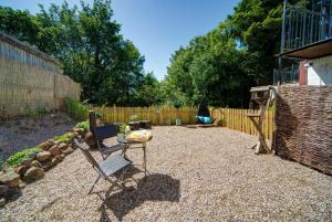 a yard with a chair and a fence at The Retreat Studio in Carlisle