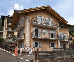 a building with balconies on the side of it at Fiemme Home Mountain Apartment in Tesero