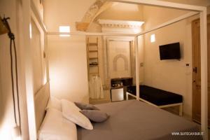 een kleine kamer met een bed en een spiegel bij Suite Cavour - Ambra in Galatina