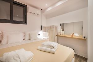 Santé Premium Suites tesisinde bir odada yatak veya yataklar