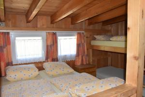 a bedroom with two bunk beds and two windows at ALTE SEKTION und Alpenblick in Flums