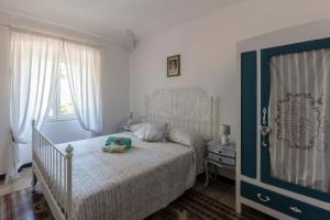 a bedroom with a bed with a teddy bear on it at La BRIGNA B&B Il bosco sul mare in Genoa
