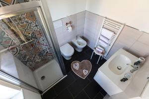 a small bathroom with a toilet and a sink at La BRIGNA B&B Il bosco sul mare in Genoa