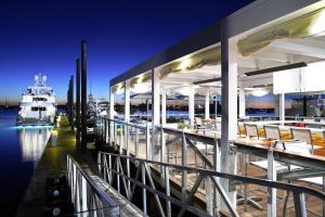 a restaurant with a boat in the water at night at Forty 1 North in Newport