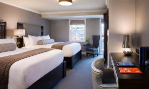 a hotel room with two beds and a desk at Forty 1 North in Newport