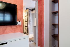 a kitchen with a tv on a wall and a room at Da Chris e Lisa - 022205-AT-296296 in Trento