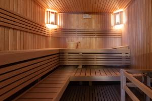 a sauna with a bench and lights in it at HOTEL AD Residence in Bormio