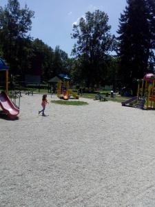 a little girl walking in a playground at Агни in Vrnjačka Banja
