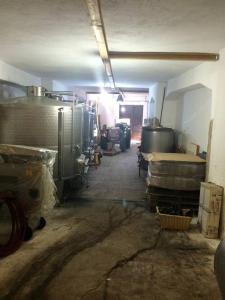 an empty garage with a room with a lot of items at A great house,food&good wine with a tour in Matera in Barile