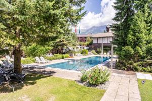 a swimming pool in the yard of a house at Laax Rancho Family Apartment in Laax