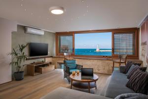 a living room with a couch and a television at Residenza Vranas Boutique Hotel in Chania Town