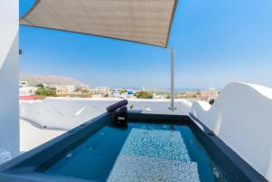 a swimming pool on the roof of a house at Pasithea Suites in Megalochori