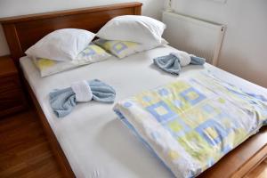 a bed with two towels and pillows on it at Relax Teslić in Teslić