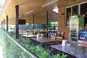 a restaurant with tables and chairs on a patio at Hotel Evrazia in Ureki