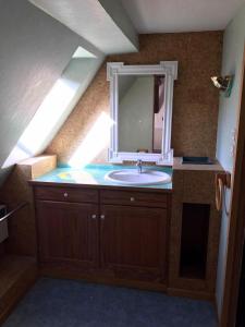 a bathroom with a sink and a mirror at GITE DES FORGERONS in Dambach-la-Ville