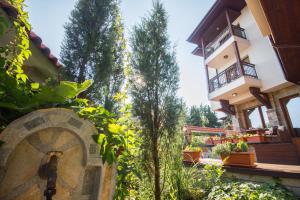a house with a garden in front of it at Breeze Guest House in Chernomorets