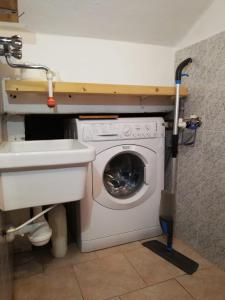a washing machine in a bathroom with a sink at La casa di Ginger - Malpensa in Cardano al Campo
