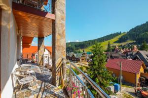 a balcony with chairs and a view of a town at Sadyba u Halyny in Bukovel