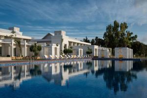 a large swimming pool in front of a building at Marchica Lagoon Resort in Nador