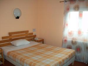 Postel nebo postele na pokoji v ubytování Hotel L'Aiglon