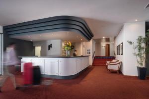 uma pessoa a atravessar um átrio de um edifício em Hotel Pestana Cascais Ocean & Conference Aparthotel em Cascais mais 37 fotografias