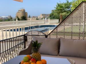 a bowl of fruit on a table on a balcony at Apartaments Bastion in Torremolinos