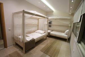 a bedroom with two bunk beds in a room at Aerides Luxury Villa in Paleo Tsifliki