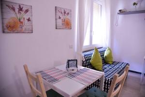 a table and a chair with a table and a window at Vatican Mirò Holidays in Rome +31 photos