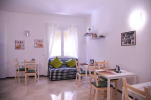 a dining room with a table and chairs and a window at Vatican Mirò Holidays in Rome