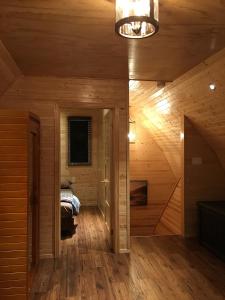 a room with a bed in a wooden cabin at Sandy Shore Cottages Luxury Resort on Rice Lake in Harwood +146 photos