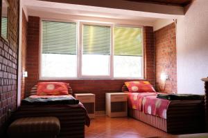 a room with two beds and two windows at Apartment Forest and Lake in Lagadin