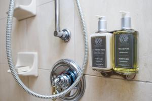 a bathroom with two soap dispensers on a wall at Mayflower Park Hotel in Seattle +50 photos