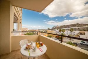 a balcony with a table and a view of a city at Casa Sara en Los Cristianos in Los Cristianos