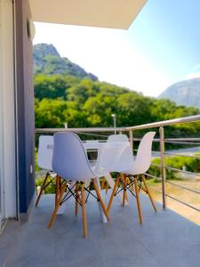 a table and chairs on a balcony with a view at Rosi`s Apartment in Sutomore