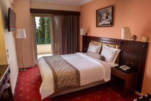 a hotel room with a large bed and a balcony at Hotel Pella in Giannitsa +120 photos