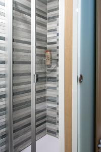 a shower with a glass door in a bathroom at Pensión Laurel in Logroño