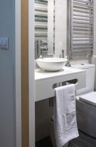 a bathroom with a white sink and a toilet at Pensión Laurel in Logroño