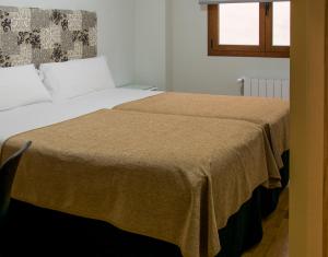 1 dormitorio con 2 camas y ventana en Pensión Laurel en Logroño