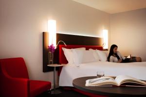 a hotel room with a bed and a desk at Mercure Paris CDG Airport & Convention in Roissy-en-France