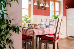 a dining room with a table and chairs with a tablecloth at Komfort Ferienwohnungen Reit im Winkl - Haus Davis in Reit im Winkl