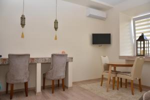 a dining room with a table and chairs at M.K. Apartments in Vilnius