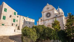 a large building with a clock tower and stairs at Apartment Star Danica*** in Šibenik