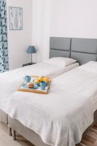 a tray of fruit sitting on a bed at APARTEL Piaseczno in Piaseczno