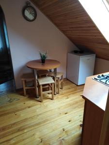 a kitchen with a table and chairs and a refrigerator at Apartment in Central Trakai in Trakai