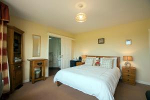 a bedroom with a bed with a teddy bear on it at The Hawthorns B & B in Mey