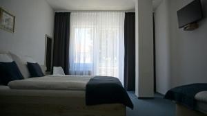 Postel nebo postele na pokoji v ubytování Hotel Metropol CB + 18 fotografií